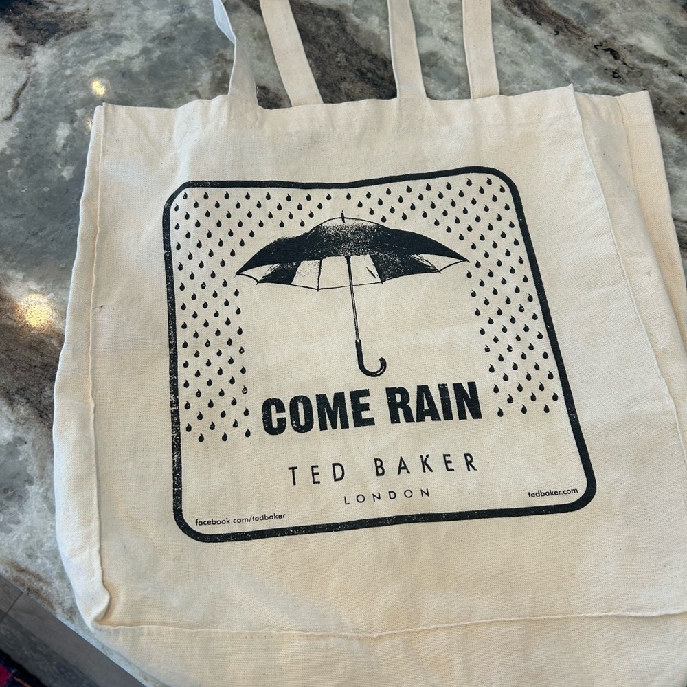 Ted Baker cream Tote with Umbrella Graphic has hole on side stains
